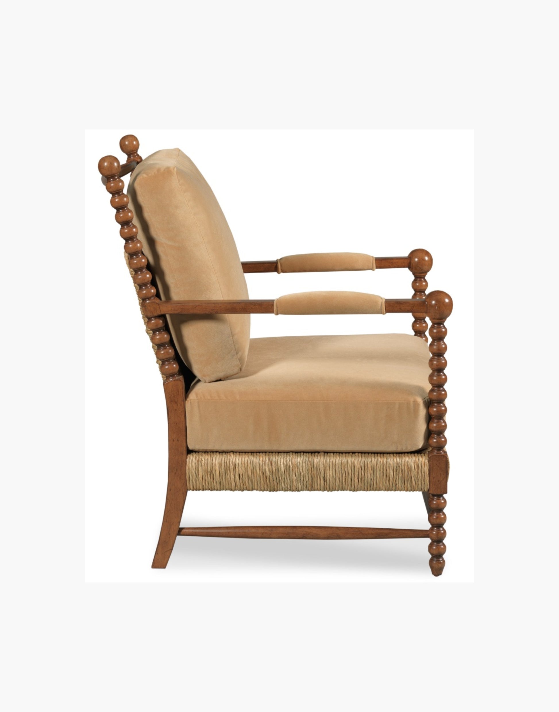 Lounge Chair with bobbin-turned posts, loose upholstered cushions over woven rush seat and back, paddle arms with padded upholstery, hardwood solids, finished in Praline with Banks Caramel Velvet upholstery.
