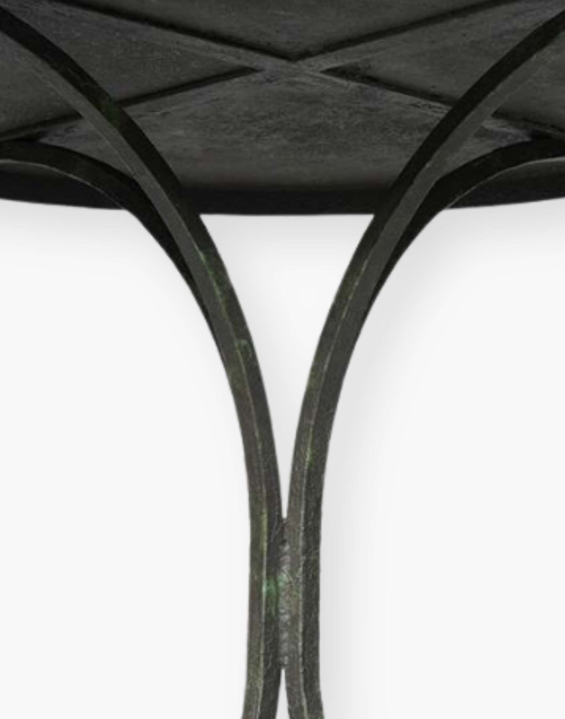 18th century French inspired guéridon with a honed metal top over four shaped metal legs.