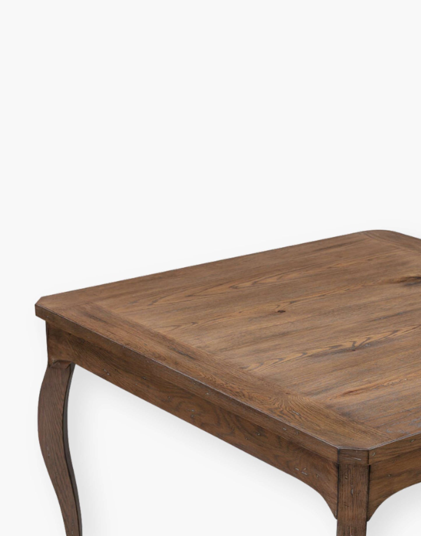 Oak solid and veneer game table with shaped cabriole legs that are joined by shaped apron rails below a squared top with canted corners.