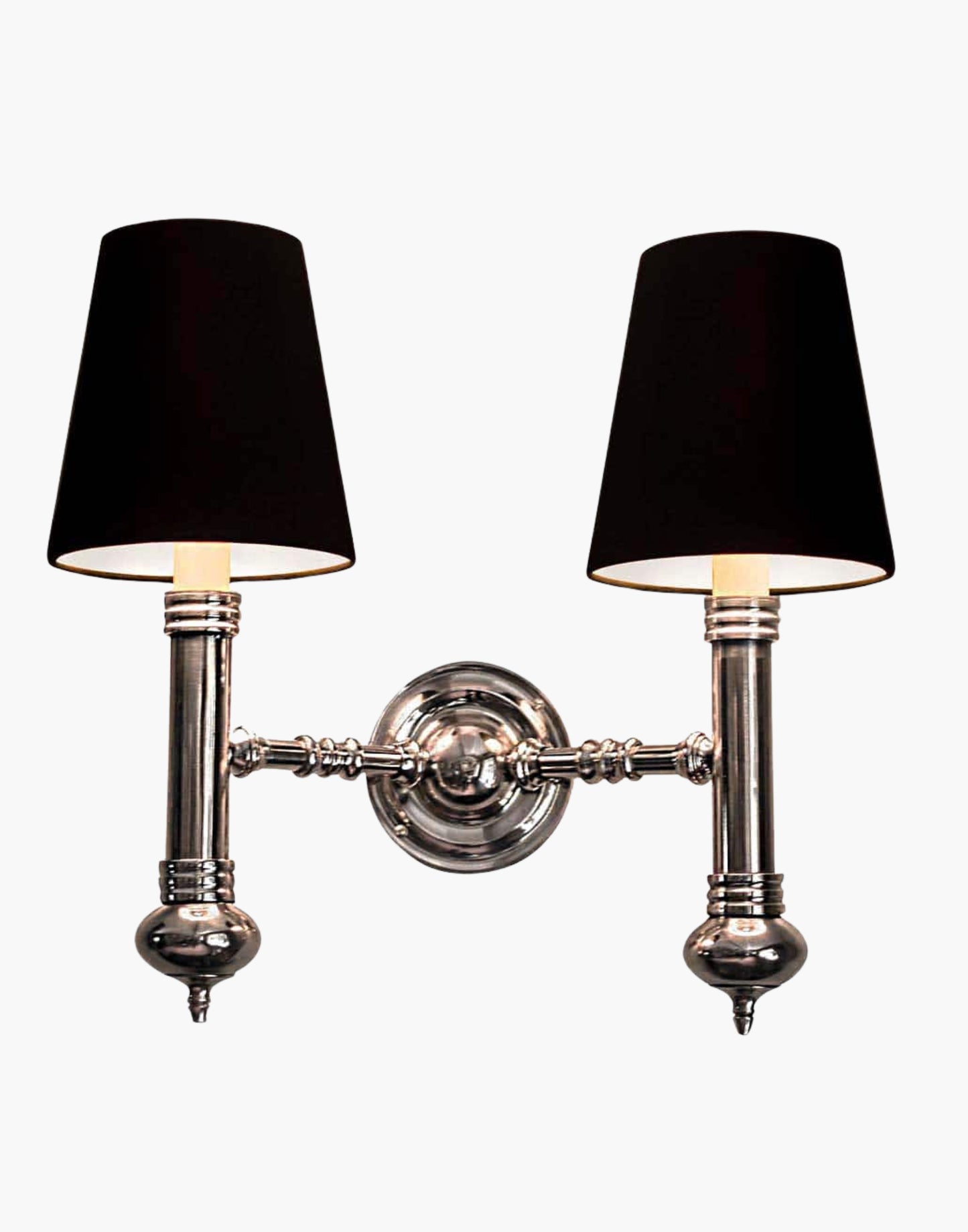 Twin Wall Sconce in cast brass, compact period-style double wall light creating warm ambient illumination.