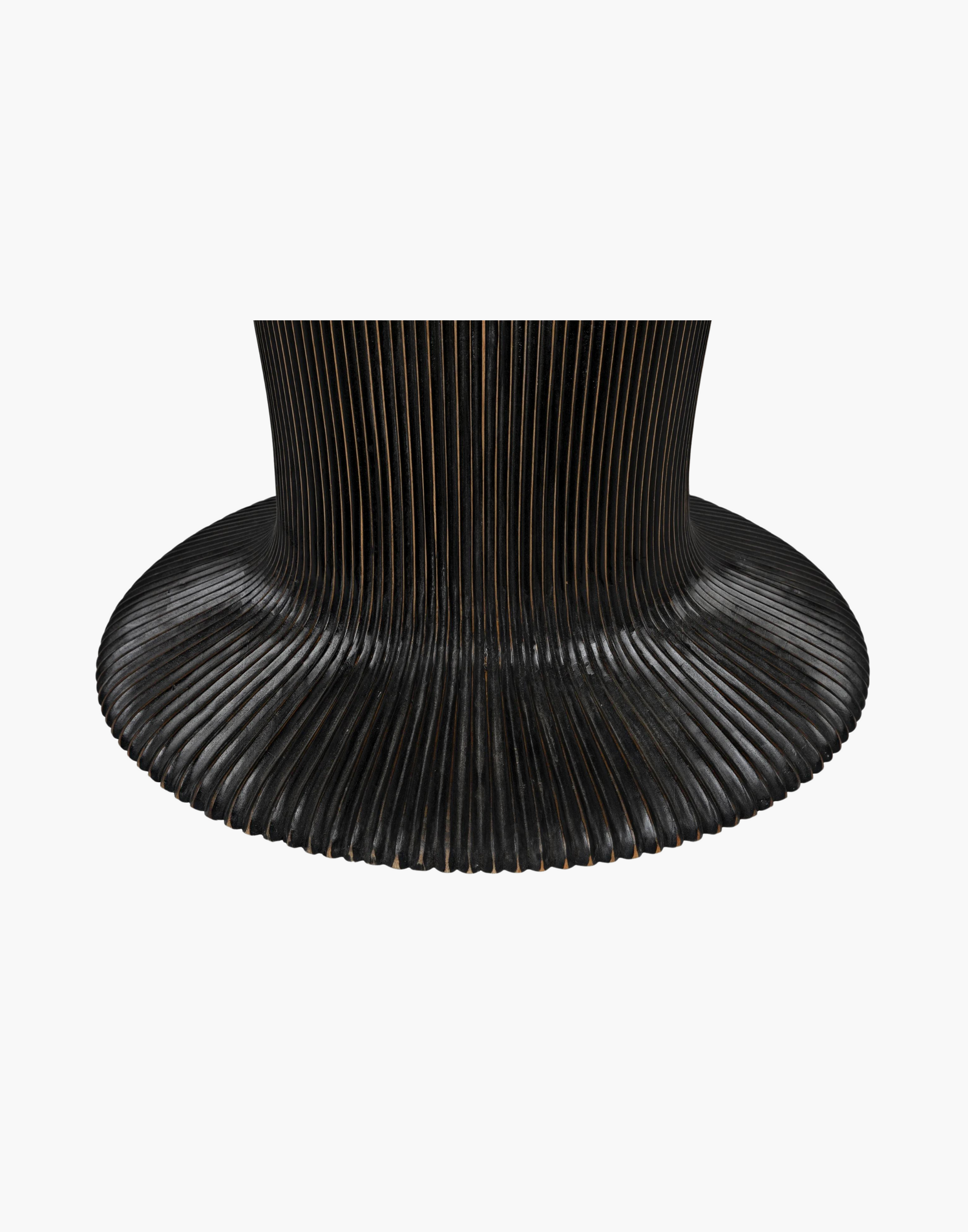 Detailed dining table with ribbing effect over the body and top edge with a hand rubbed black finish.