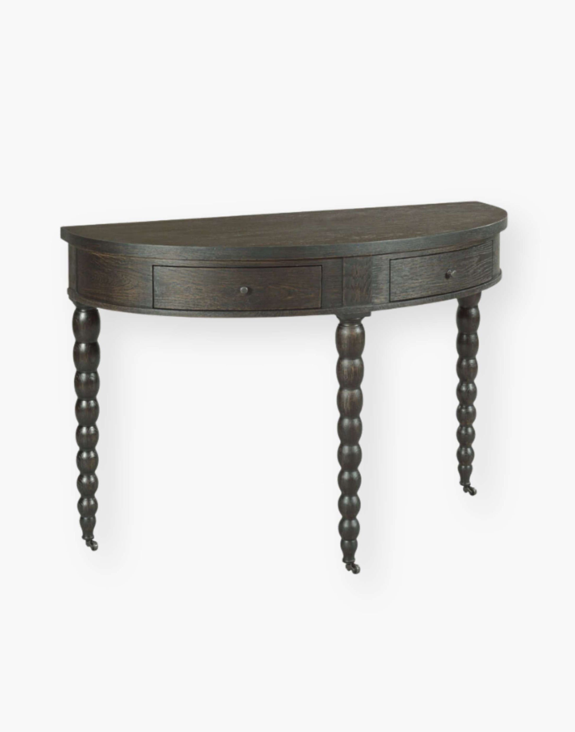 apron rail table fitted with two storage drawers that are mounted with turned brass knobs and raised by spool legs in worn black finish