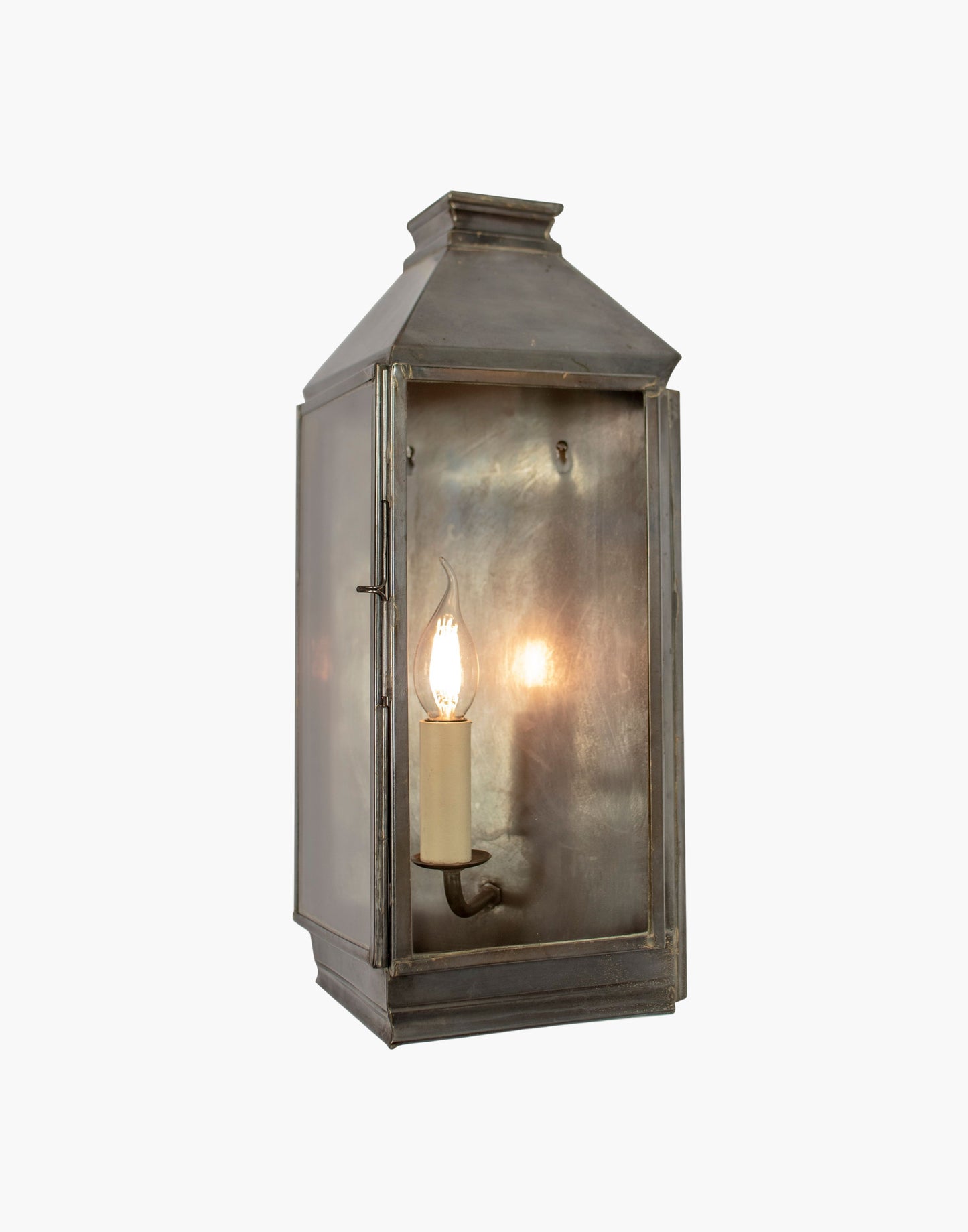Wall Lantern in solid brass featuring a classic three sided French lantern design, wet rated for outdoor walls, porches, and entryways.