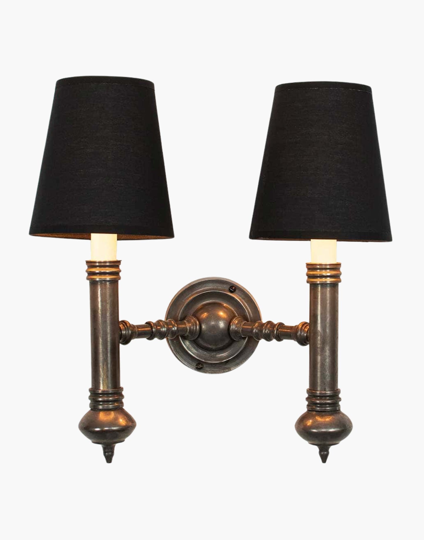 Twin Wall Sconce in cast brass, compact period-style double wall light creating warm ambient illumination.