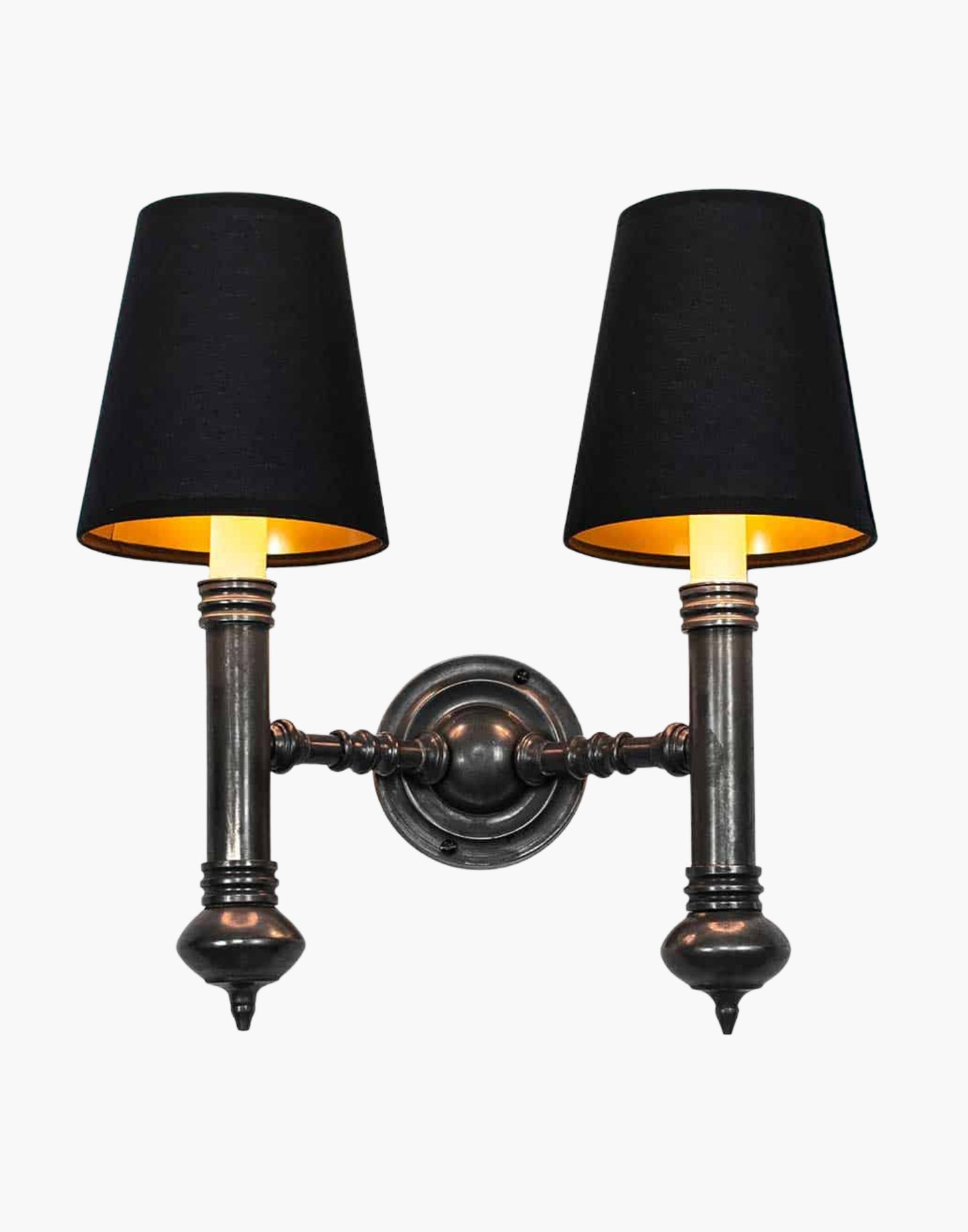 Twin Wall Sconce in cast brass, compact period-style double wall light creating warm ambient illumination.