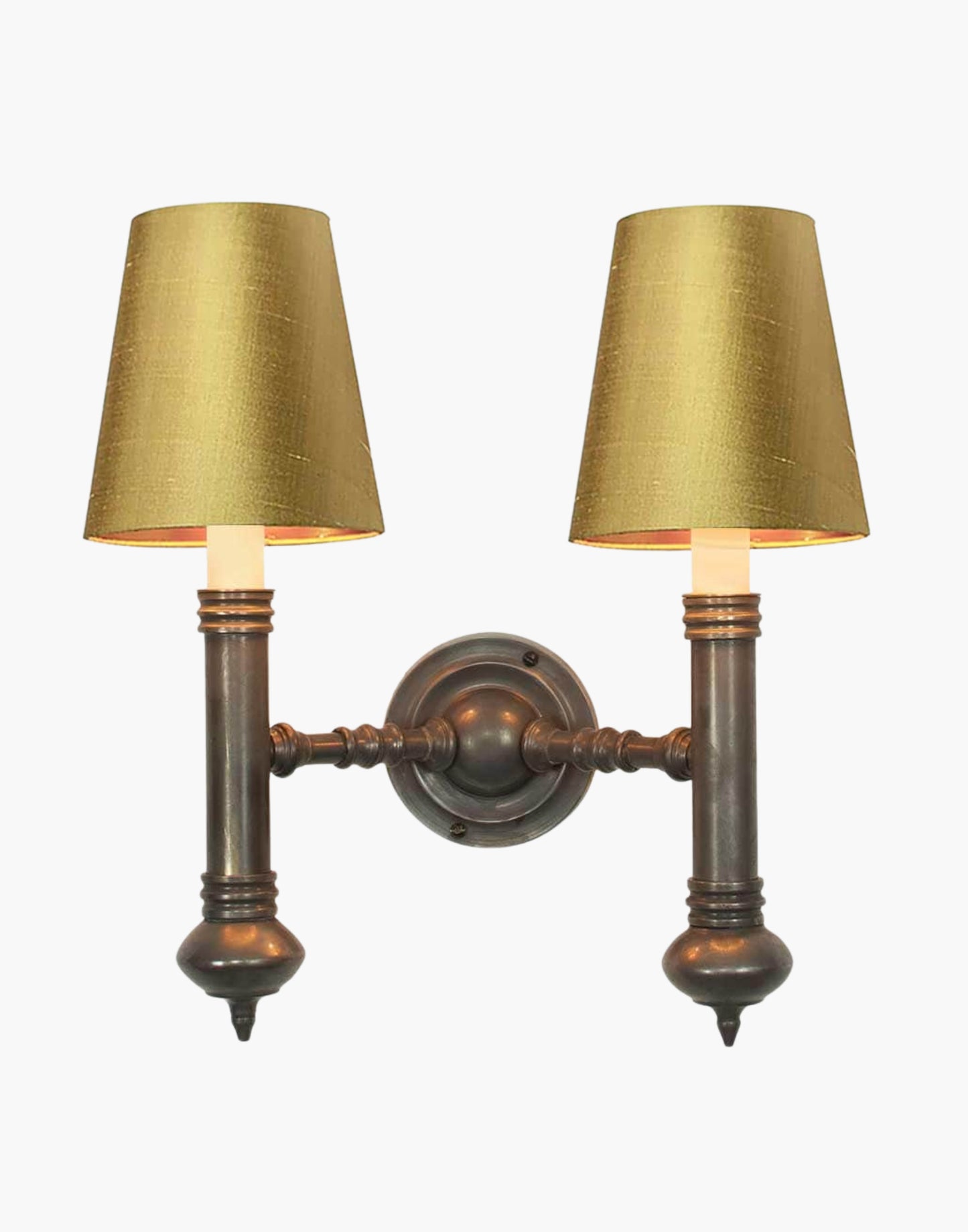 Twin Wall Sconce in cast brass, compact period-style double wall light creating warm ambient illumination.