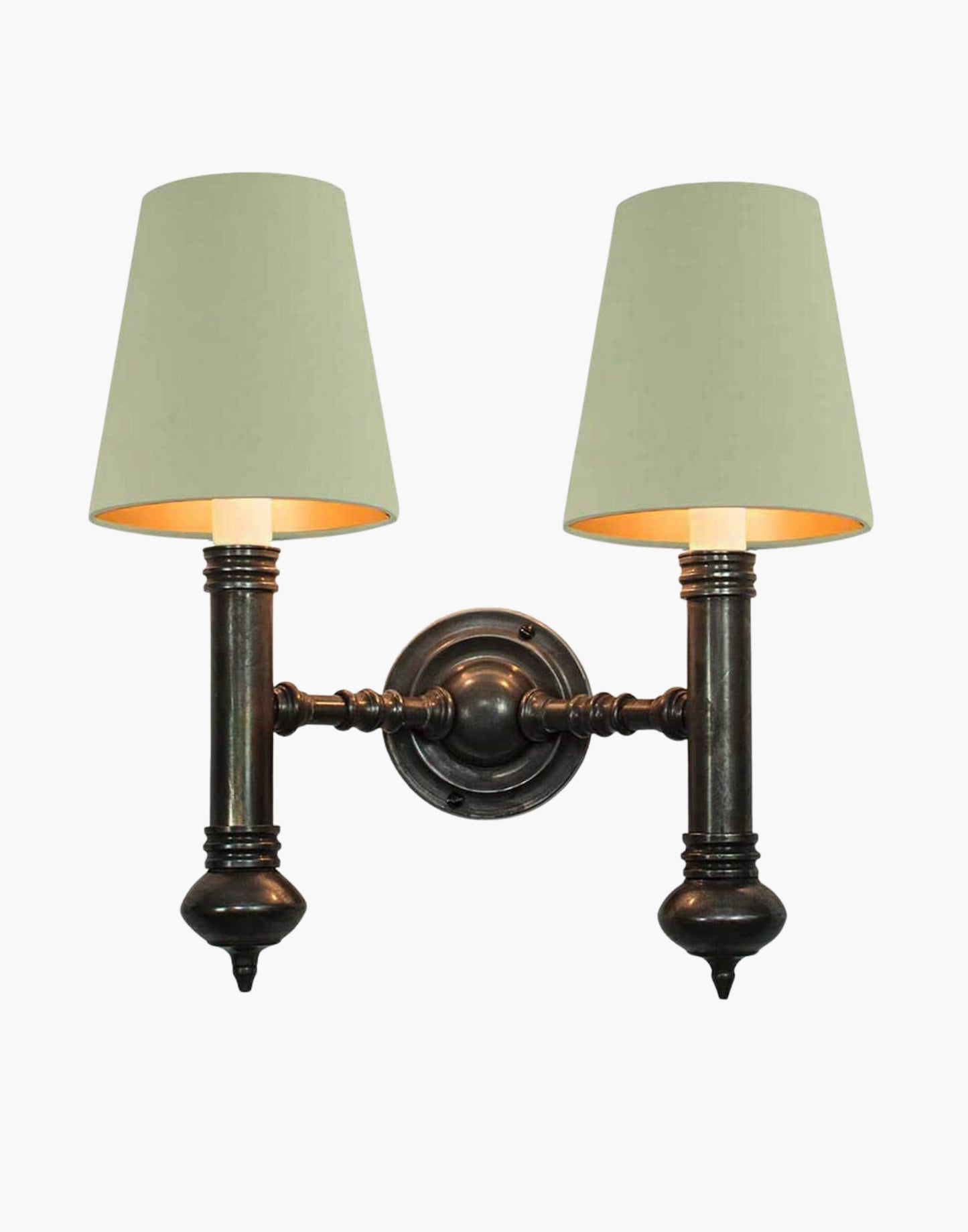 Twin Wall Sconce in cast brass, compact period-style double wall light creating warm ambient illumination.