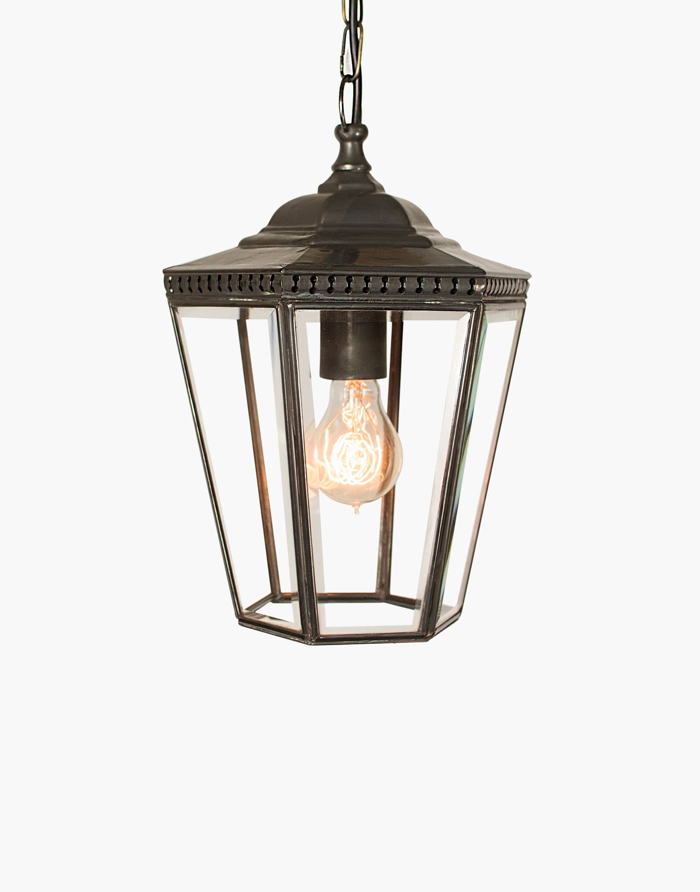 Pendant lantern in solid copper with pierced brass fretwork, beveled glass, finial and chain, suitable for damp locations.