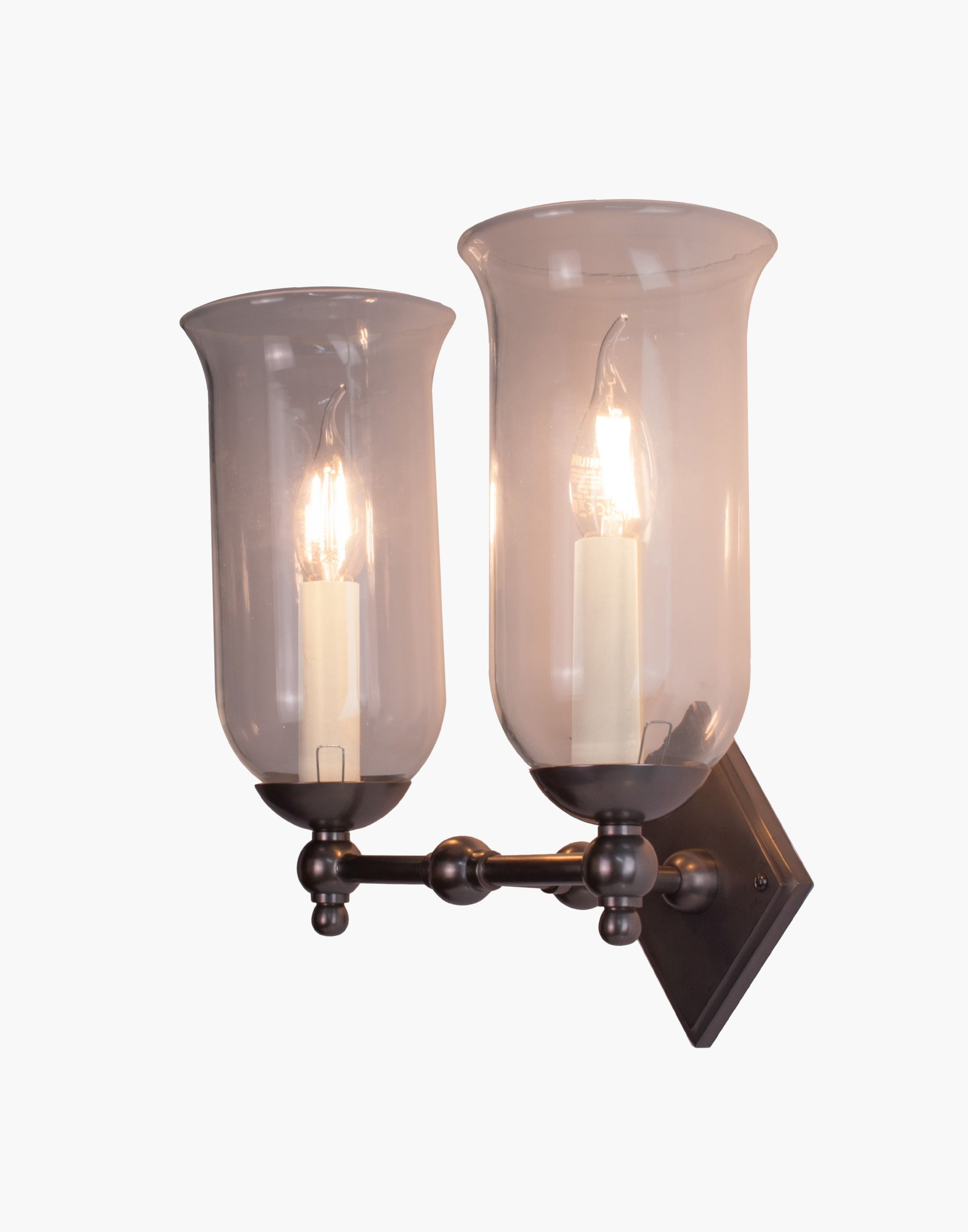 Storm Glass wall sconce twin in brass with diamond back plate, scalloped edge, and rustic storm glass shades for bathroom or interior lighting