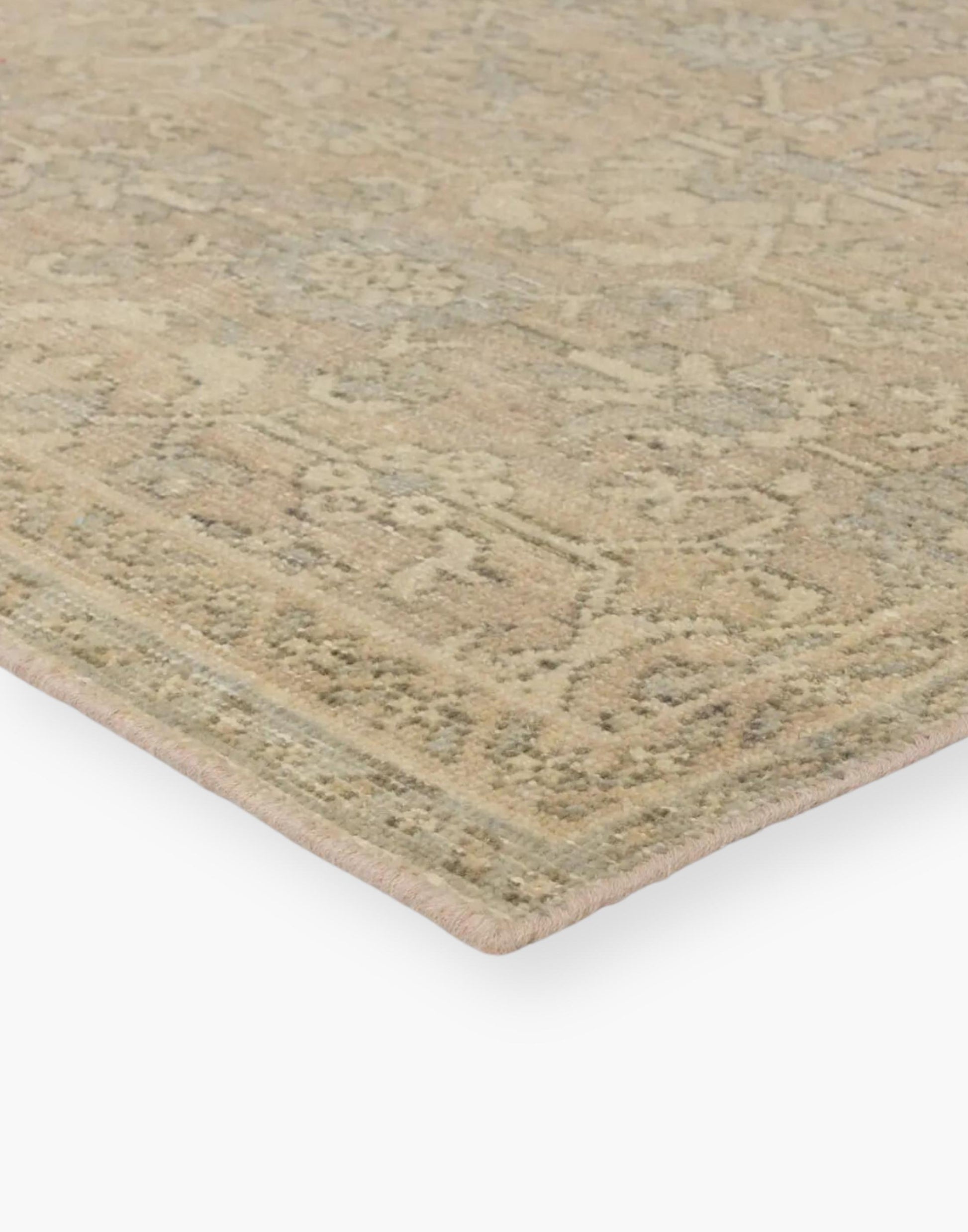 Wool rig with a distressed, floral trellis in hues of tan, gray, and cream.