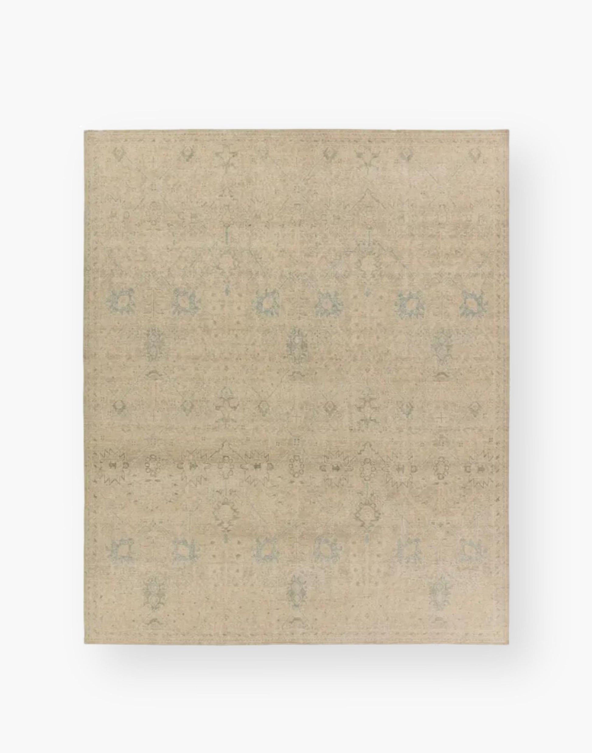 Wool rug with a distressed, floral Oushak pattern in hues of tan, blue, taupe, cream, and gray