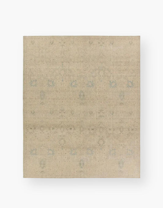 Wool rug with a distressed, floral Oushak pattern in hues of tan, blue, taupe, cream, and gray