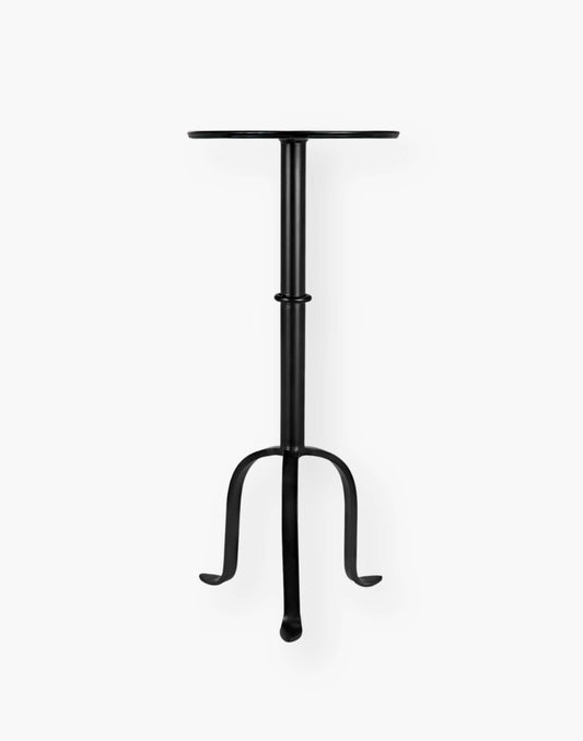Victorian-inspired metal side table with rustic charm, perfect for small spaces. Adds flair to any room setting.