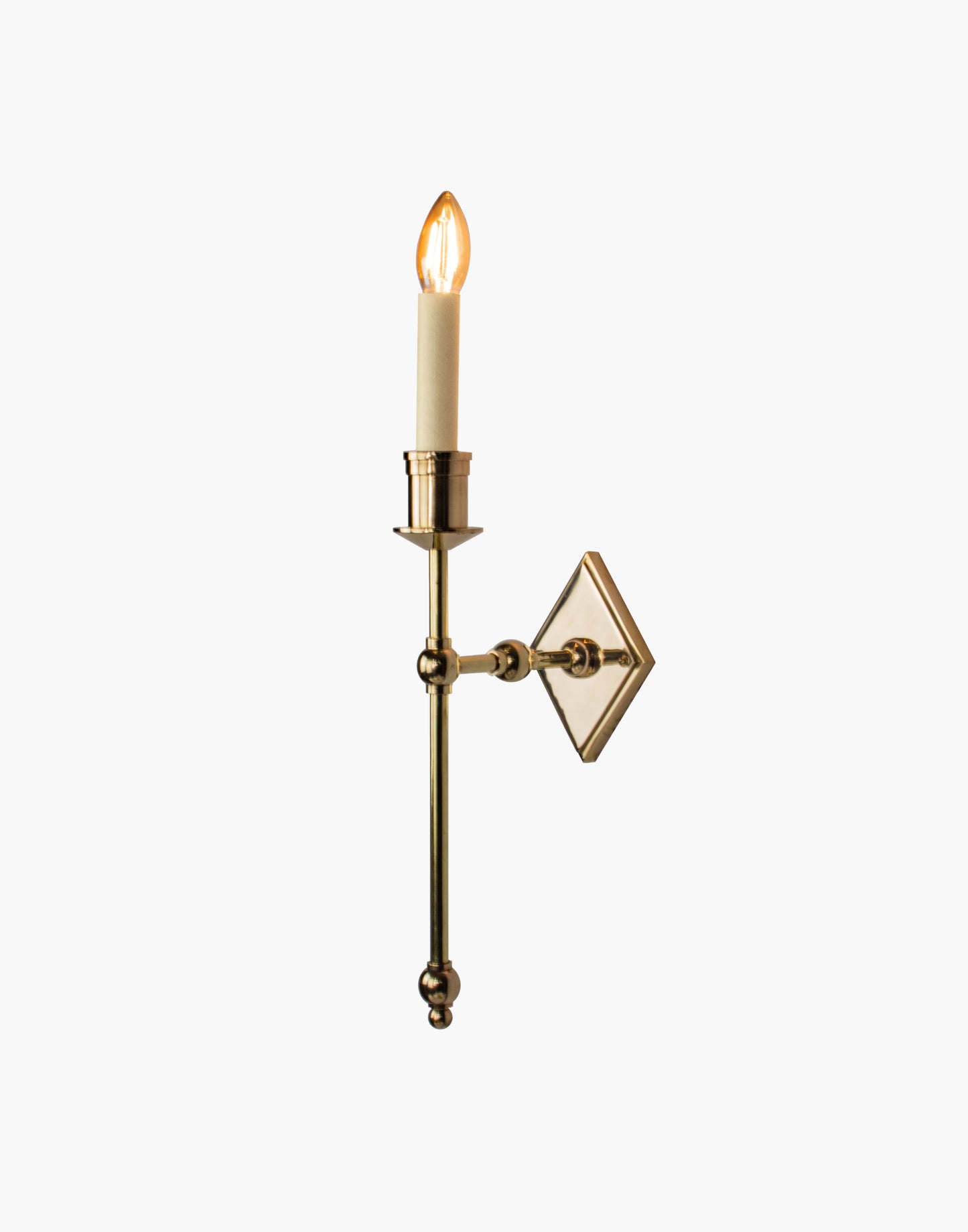 Wall sconce in cast and machined brass with diamond-shaped scalloped backplate and optional shade.