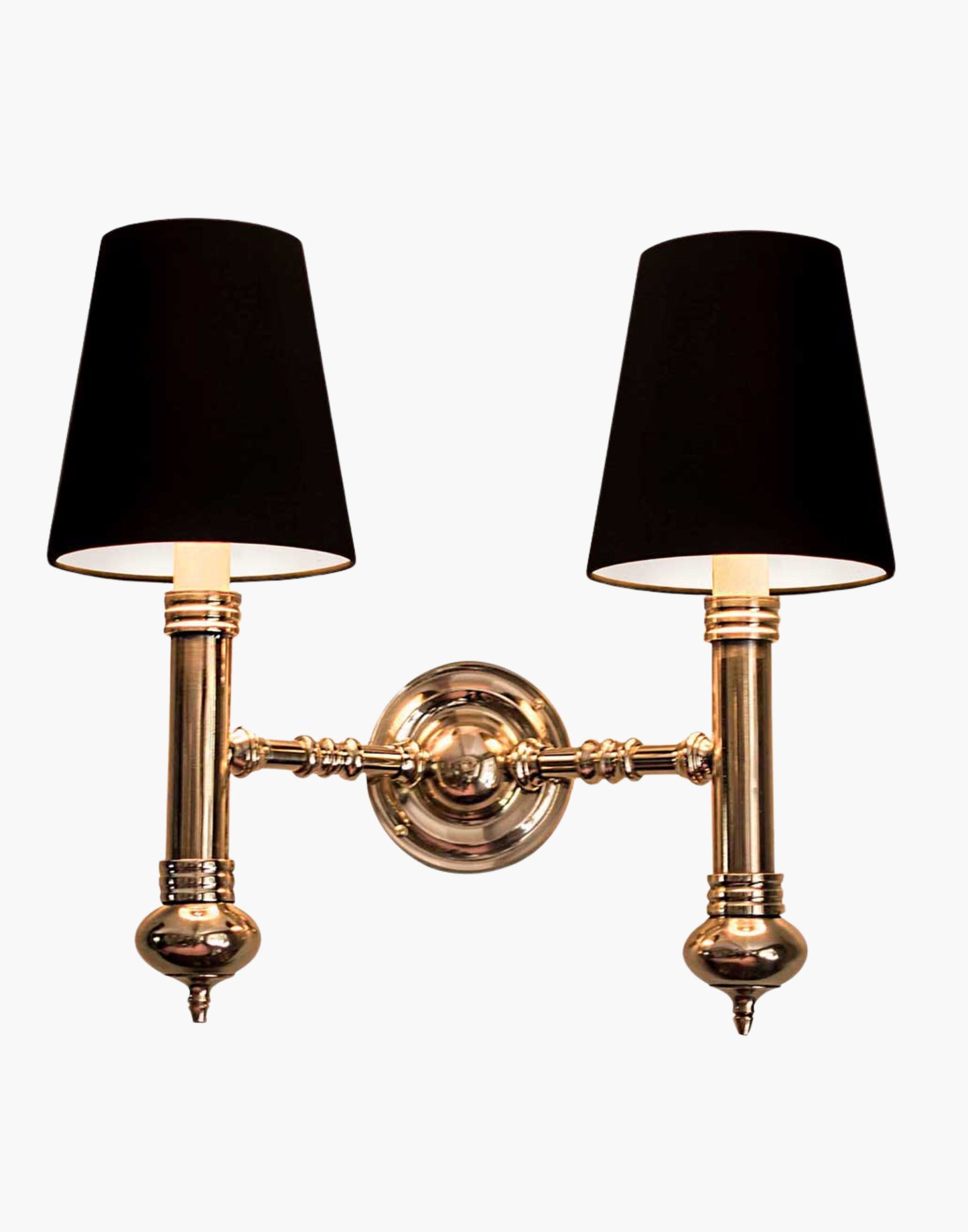 Twin Wall Sconce in cast brass, compact period-style double wall light creating warm ambient illumination.