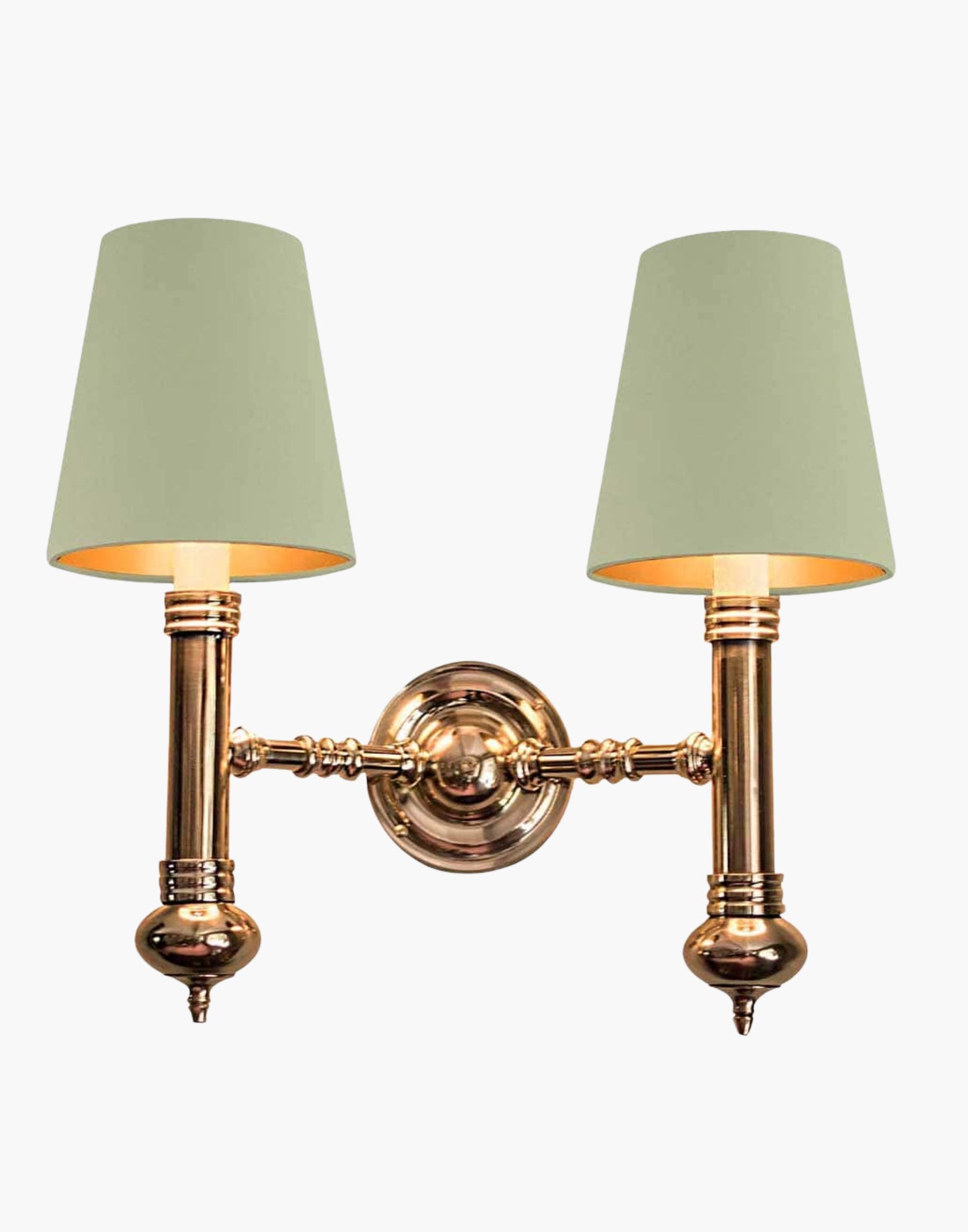 Twin Wall Sconce in cast brass, compact period-style double wall light creating warm ambient illumination.