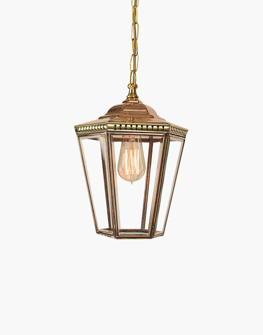 Pendant lantern in solid copper with pierced brass fretwork, beveled glass, finial and chain, suitable for damp locations.