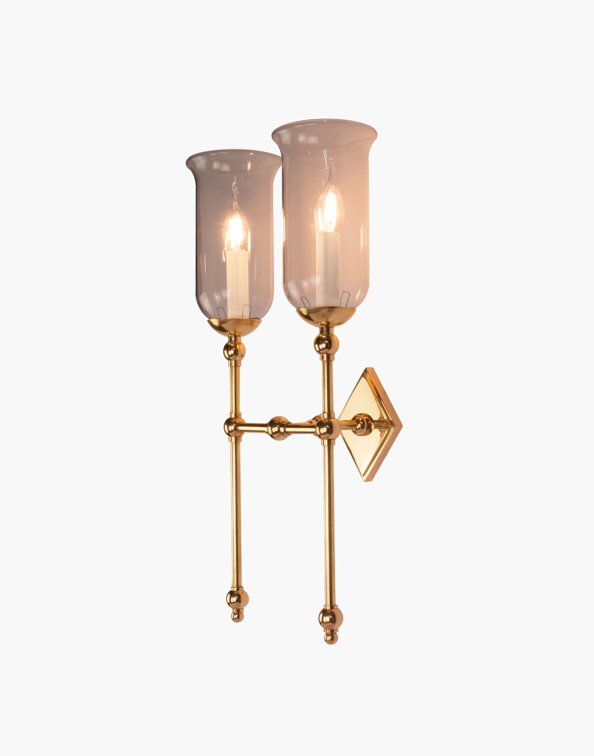 Tall Storm Glass twin wall sconce with diamond-shaped brass back plate
