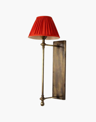 Distressed Finish with Red Pleated Shade Provencal wall lights: Elegant cast brass fixtures inspired by 19th-century French design. Customizable shades available.