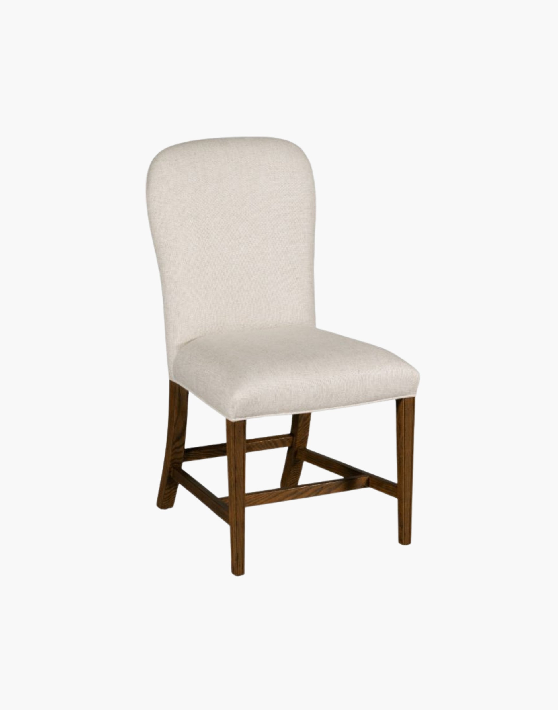 Fully upholstered gentle balloon shaped back resides over an upholstered seat with gracefully tapering legs.
