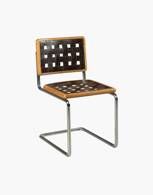 The Renewal Chair has a polished nickel base and leather straps.