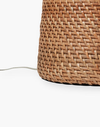 Jug-style table lamp covered in flat-weave glossy rattan in a dark honey finish.