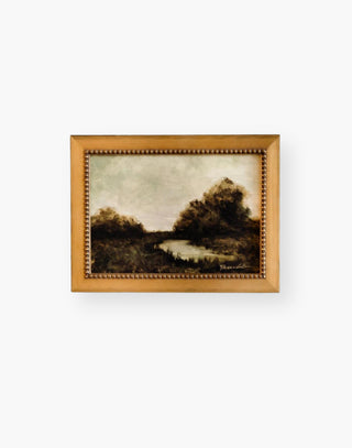 Small gold framed hand signed artwork of river and trees by Diana Brambila