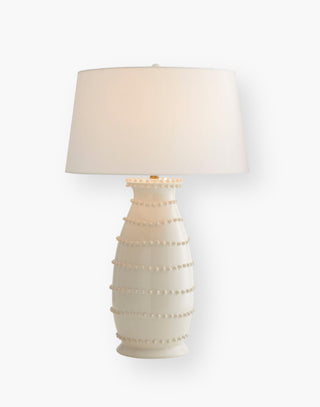 Ceramic Table Lamp accented with hand-applied soft beaded bumps topped with an off-white microfiber shade lined in a matching off-white cotton shade.