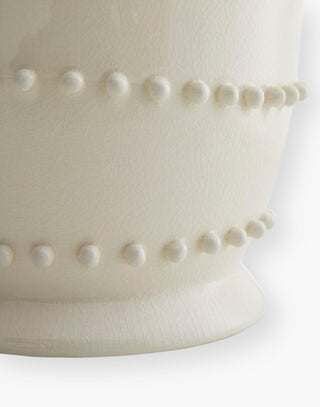 Ceramic Table Lamp accented with hand-applied soft beaded bumps topped with an off-white microfiber shade lined in a matching off-white cotton shade.