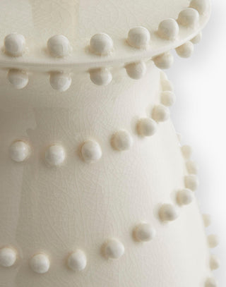 Ceramic Table Lamp accented with hand-applied soft beaded bumps topped with an off-white microfiber shade lined in a matching off-white cotton shade.