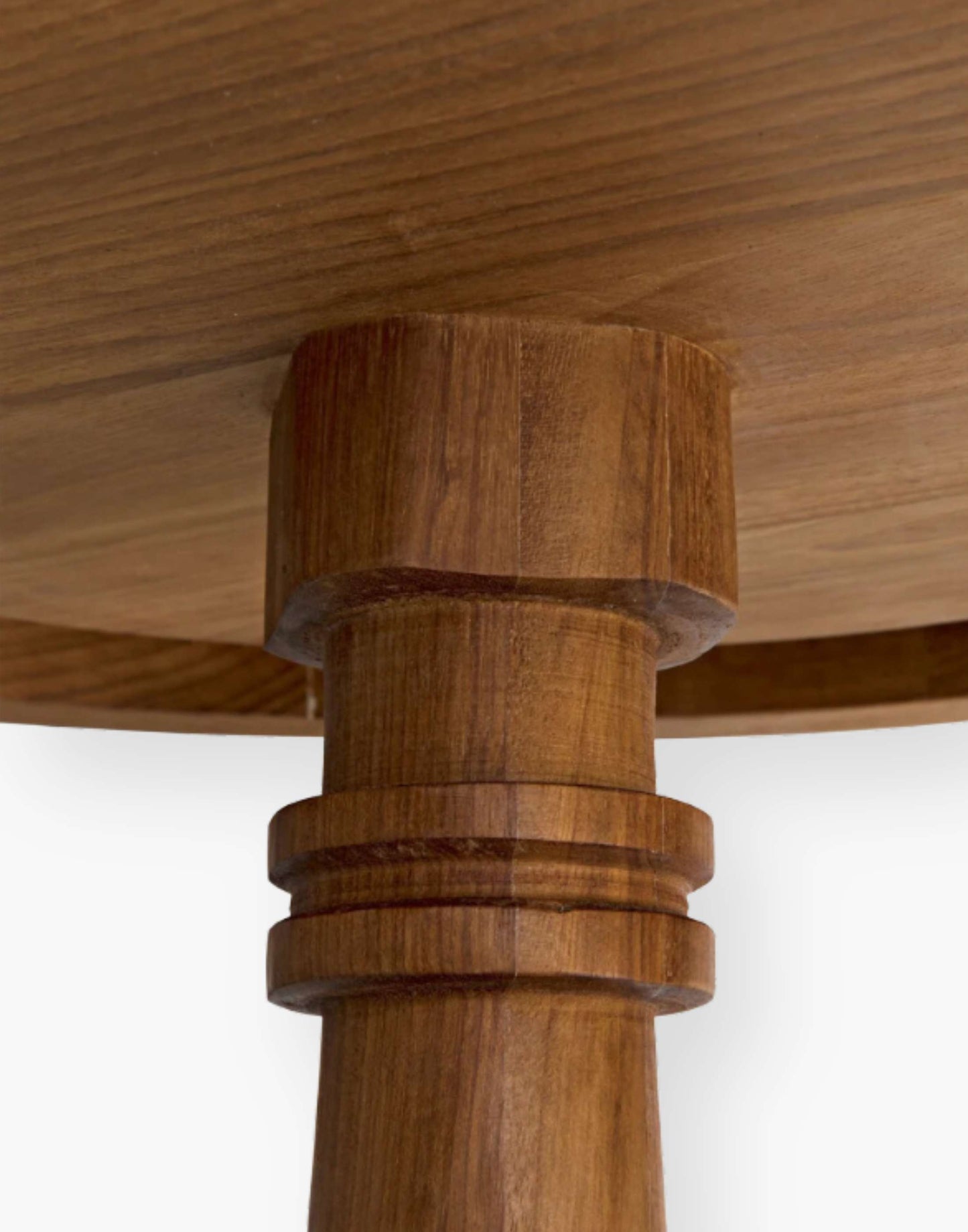 Hand-carved of solid teak side table features a circular base with coordinating round top