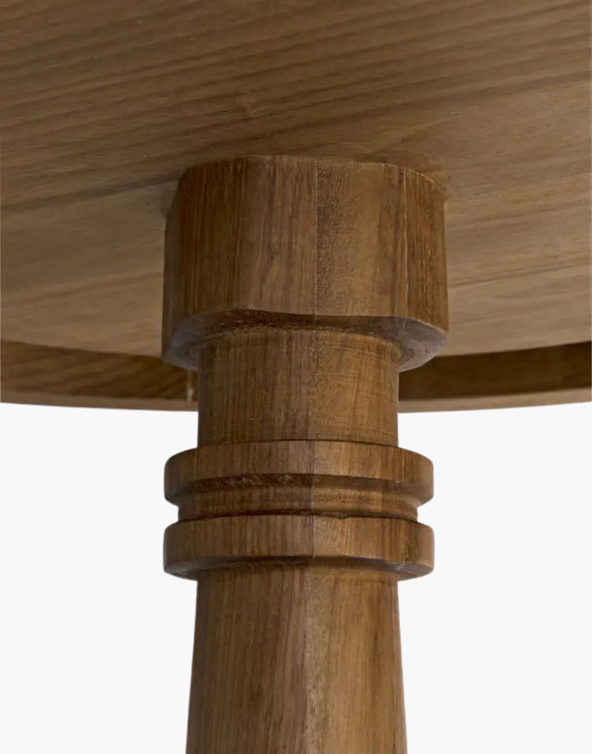 Round teak side table with gold finish and turned pedestal base, sculptural modern design