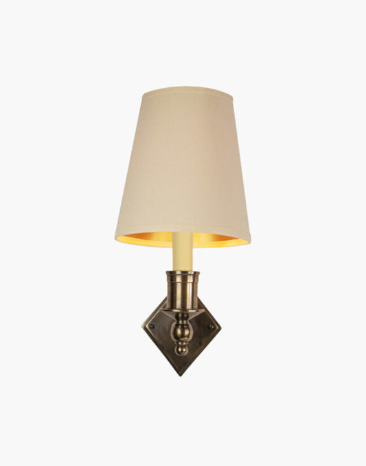 Distressed finish with d6g ivory shade, elegant solid brass sconce with diamond backplate. Perfect for modern or traditional interiors.
