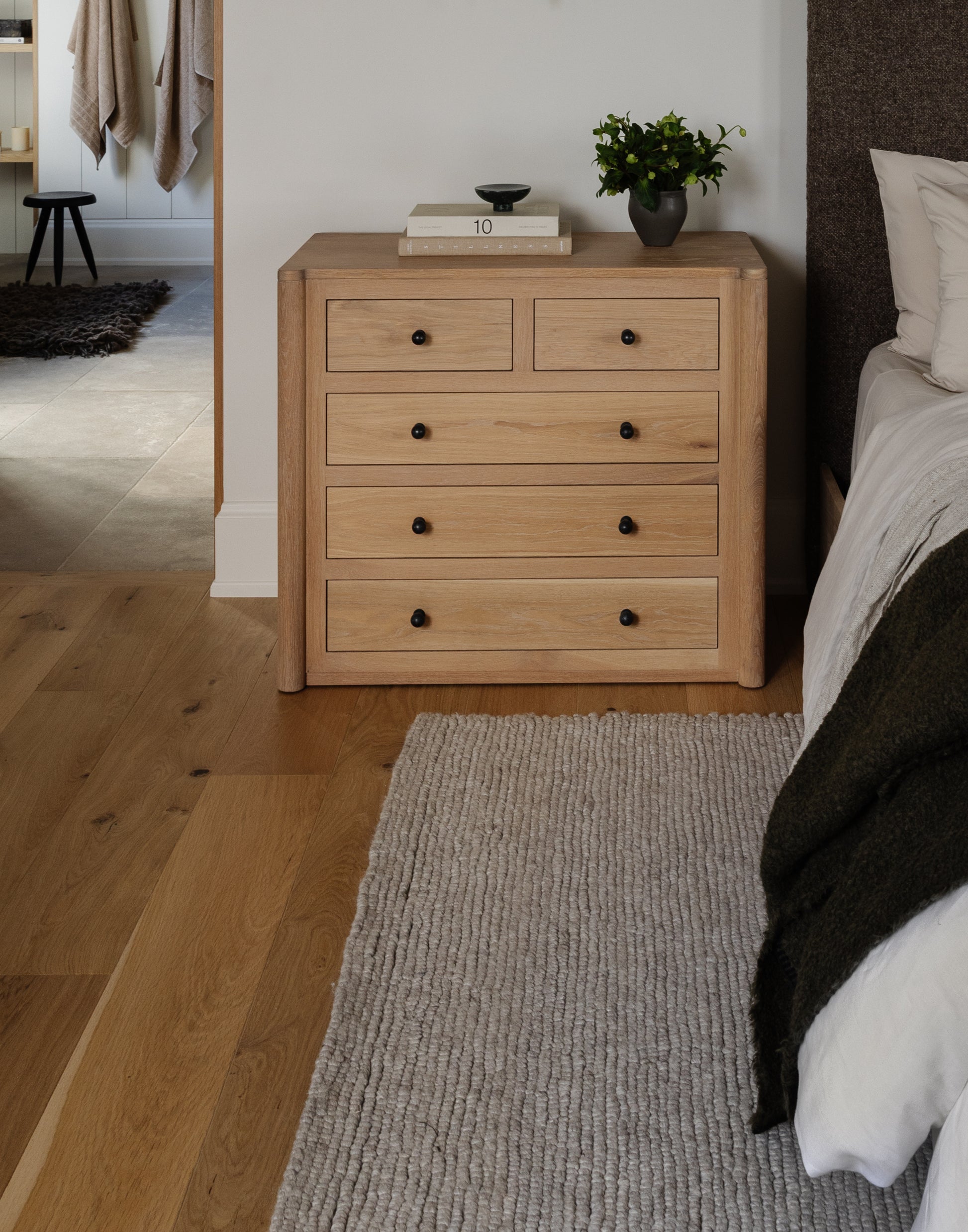 Handcrafted white oak nightstand with soft-close drawers, natural hardwax oil finish, and USB-C charging dock.