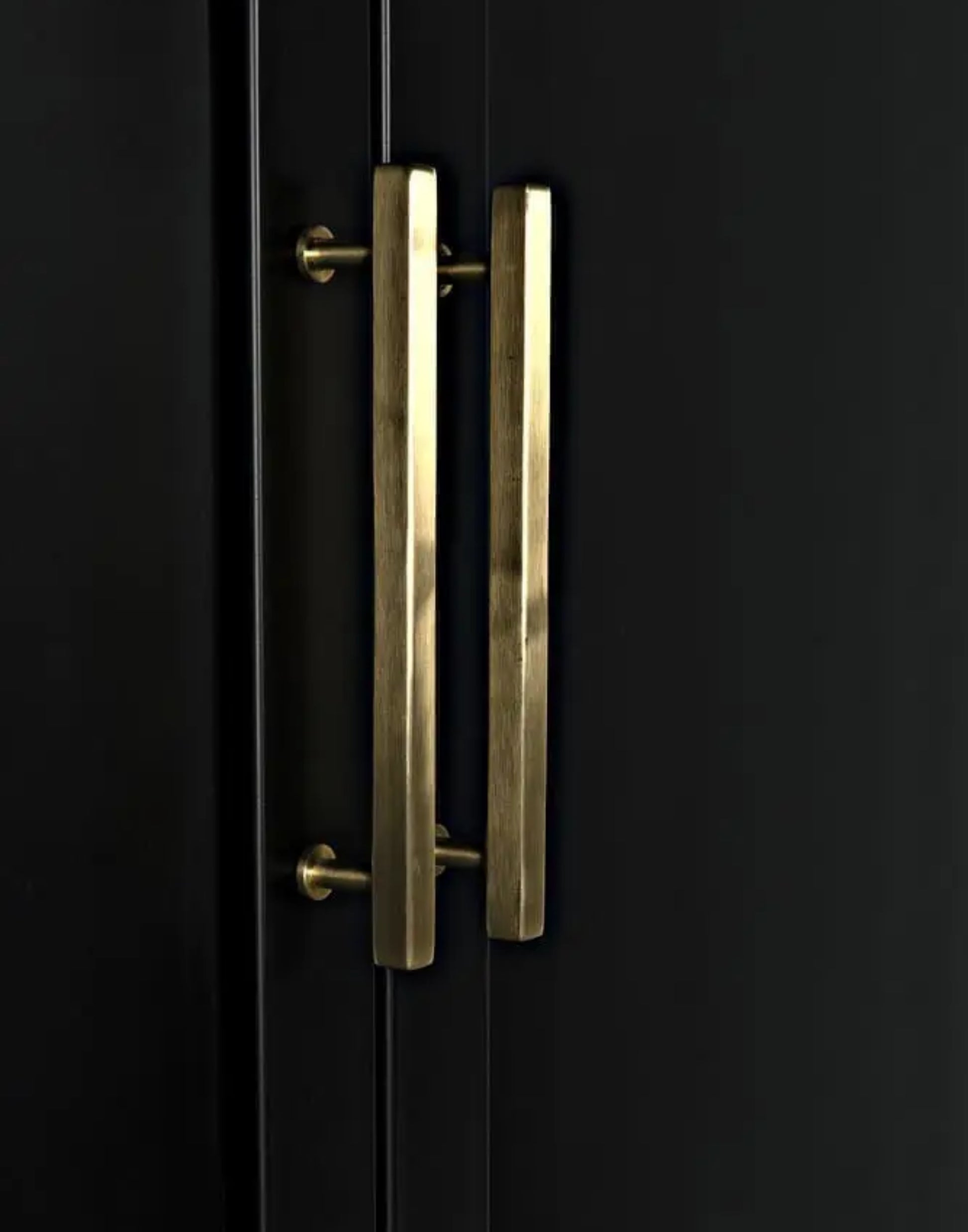 Matte black iron hutch with brass hardware and three open shelves for modern storage and display.