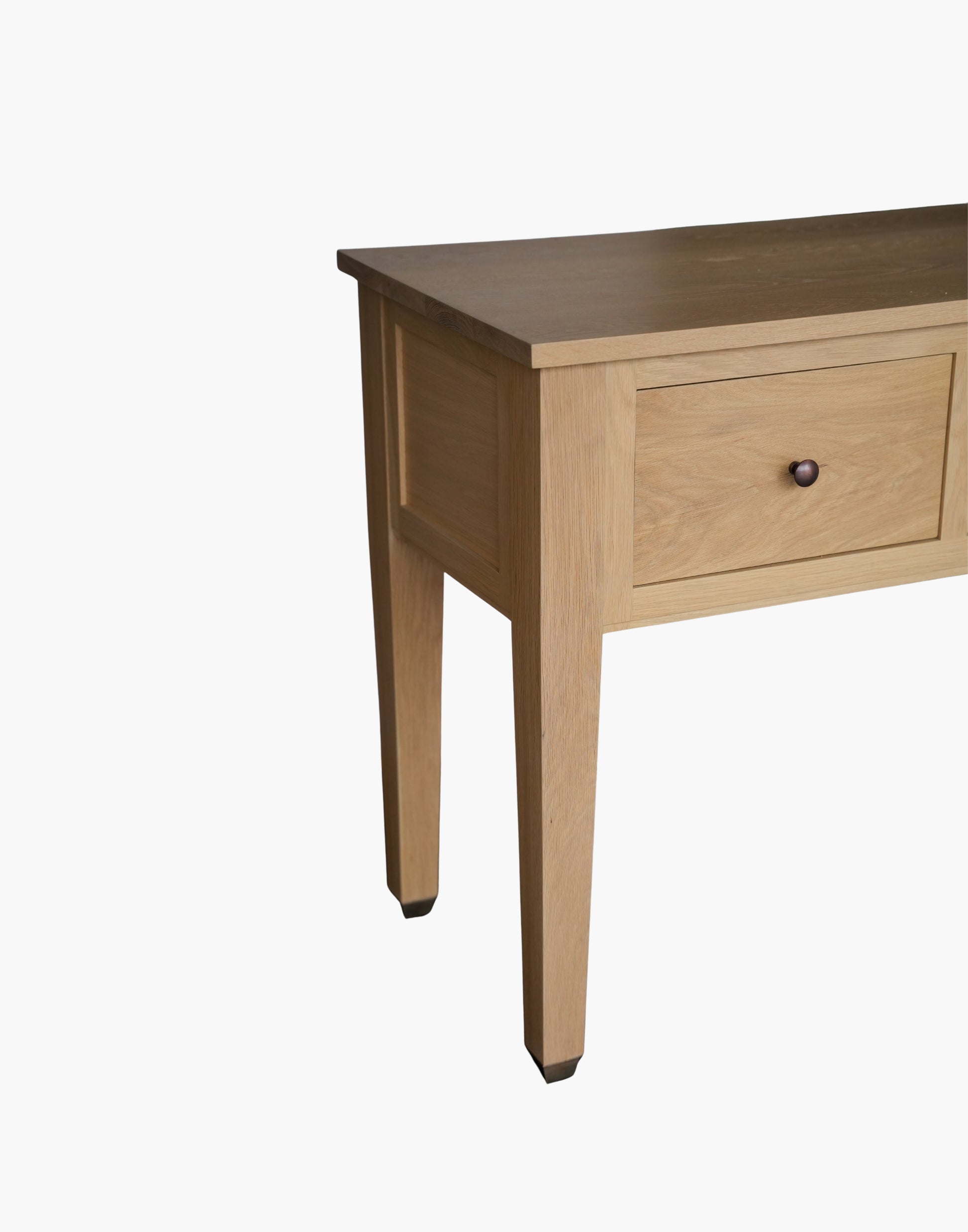 Handcrafted white oak console table with Amber Pine finish, soft-close drawers, metal caster cup feet, and integrated USB-C charging outlets.