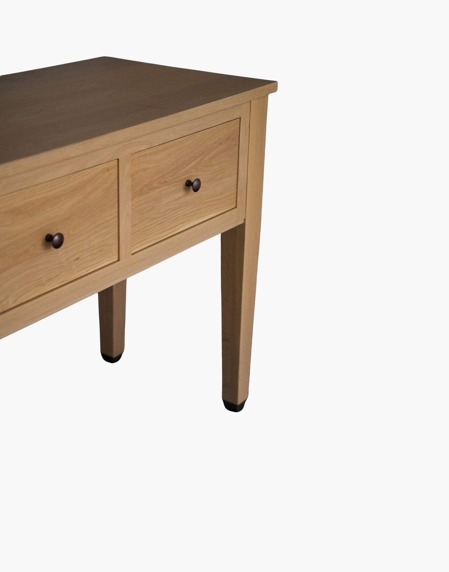 Handcrafted white oak console table with Amber Pine finish, soft-close drawers, metal caster cup feet, and integrated USB-C charging outlets.