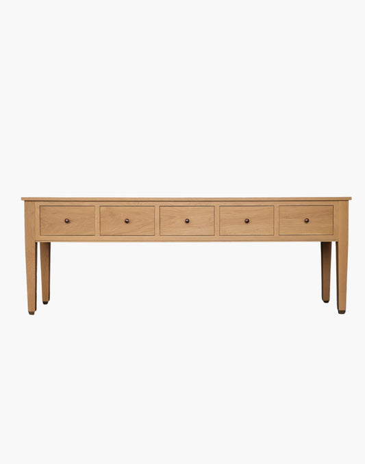 Handcrafted white oak console table with Amber Pine finish, soft-close drawers, metal caster cup feet, and integrated USB-C charging outlets.