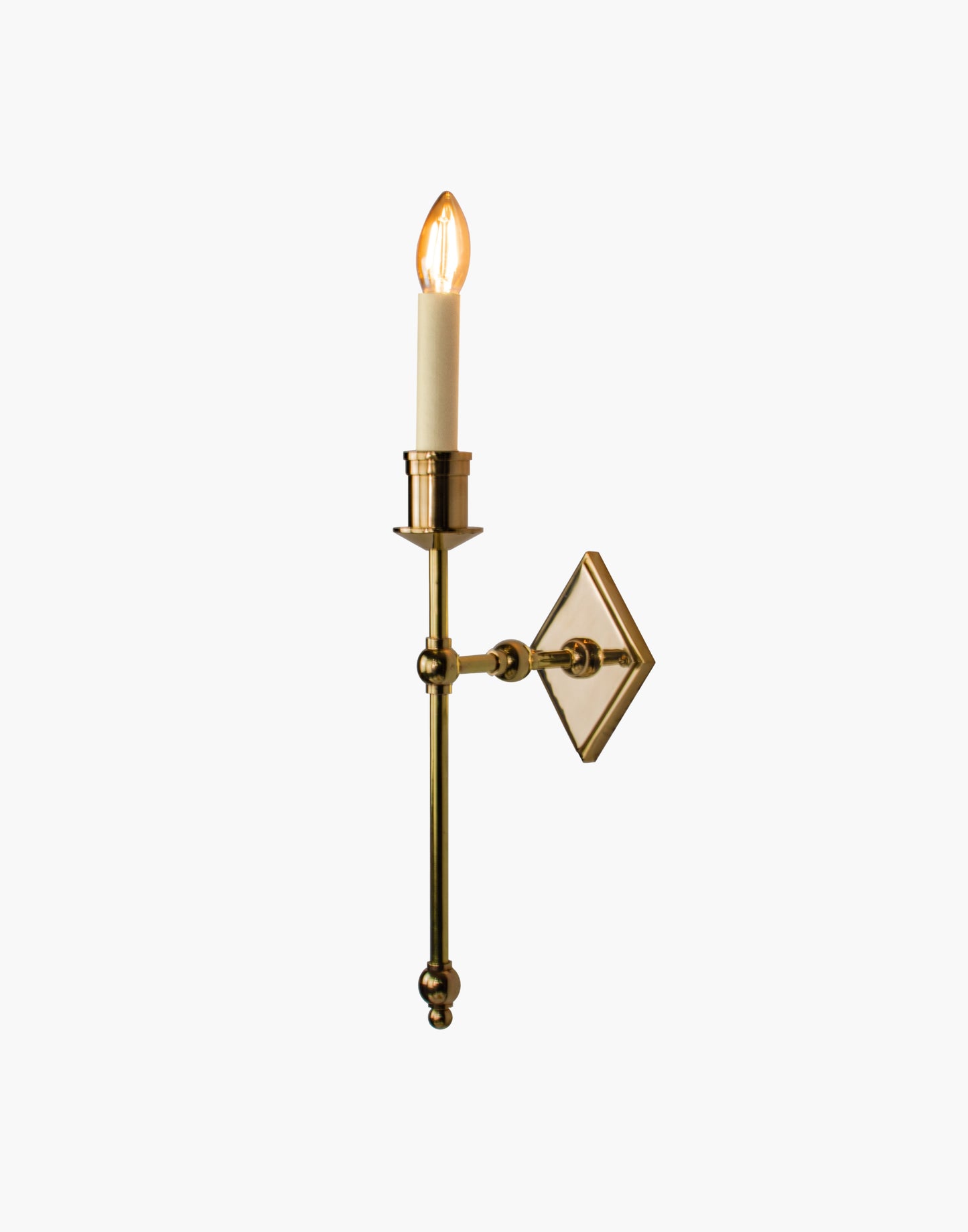 Wall sconce in cast and machined brass with diamond-shaped scalloped backplate and optional shade.