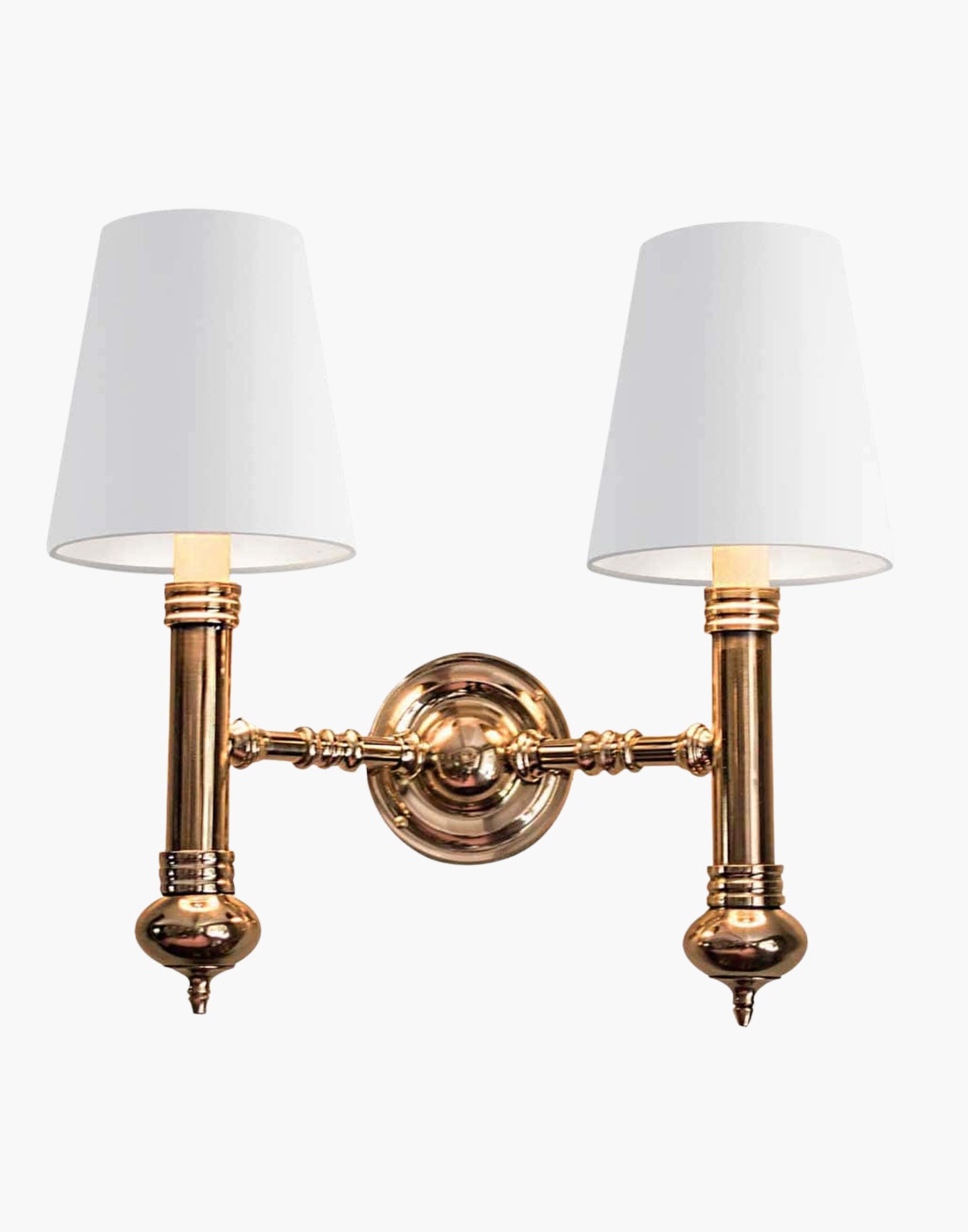 Twin Wall Sconce in cast brass, compact period-style double wall light creating warm ambient illumination.
