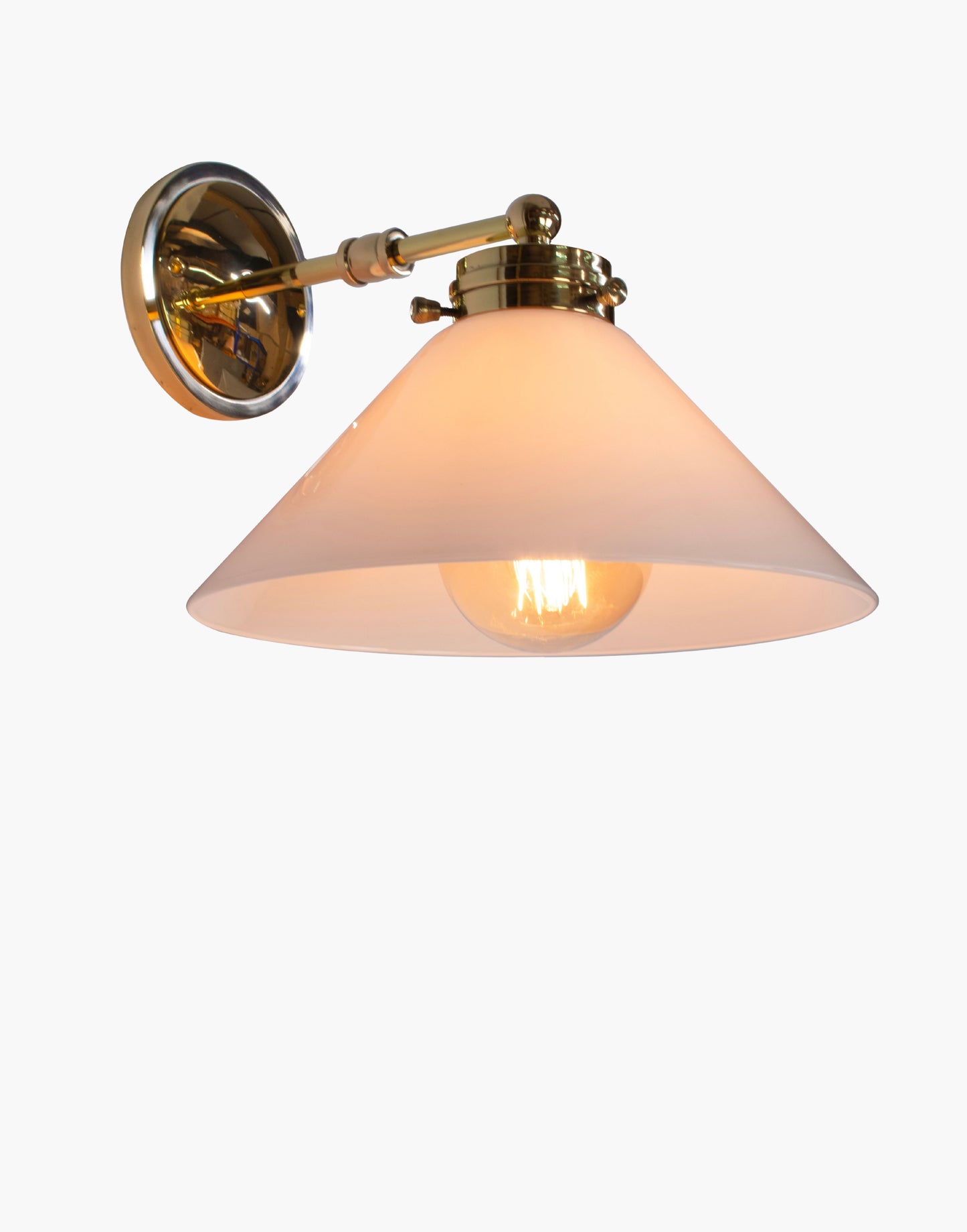 Wall light with solid brass construction, available with glass or brass shade, adjustable ambient or focused lighting for Victorian-inspired or contemporary interiors.