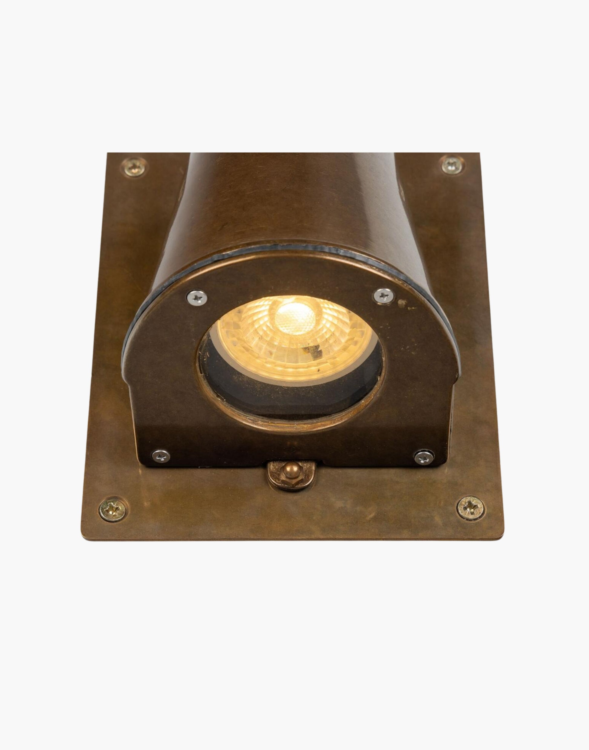 Outdoor brass wall spotlight with glass lens and compact rectangular back plate, IP54 rated, ADA compliant, designed for focused exterior lighting.