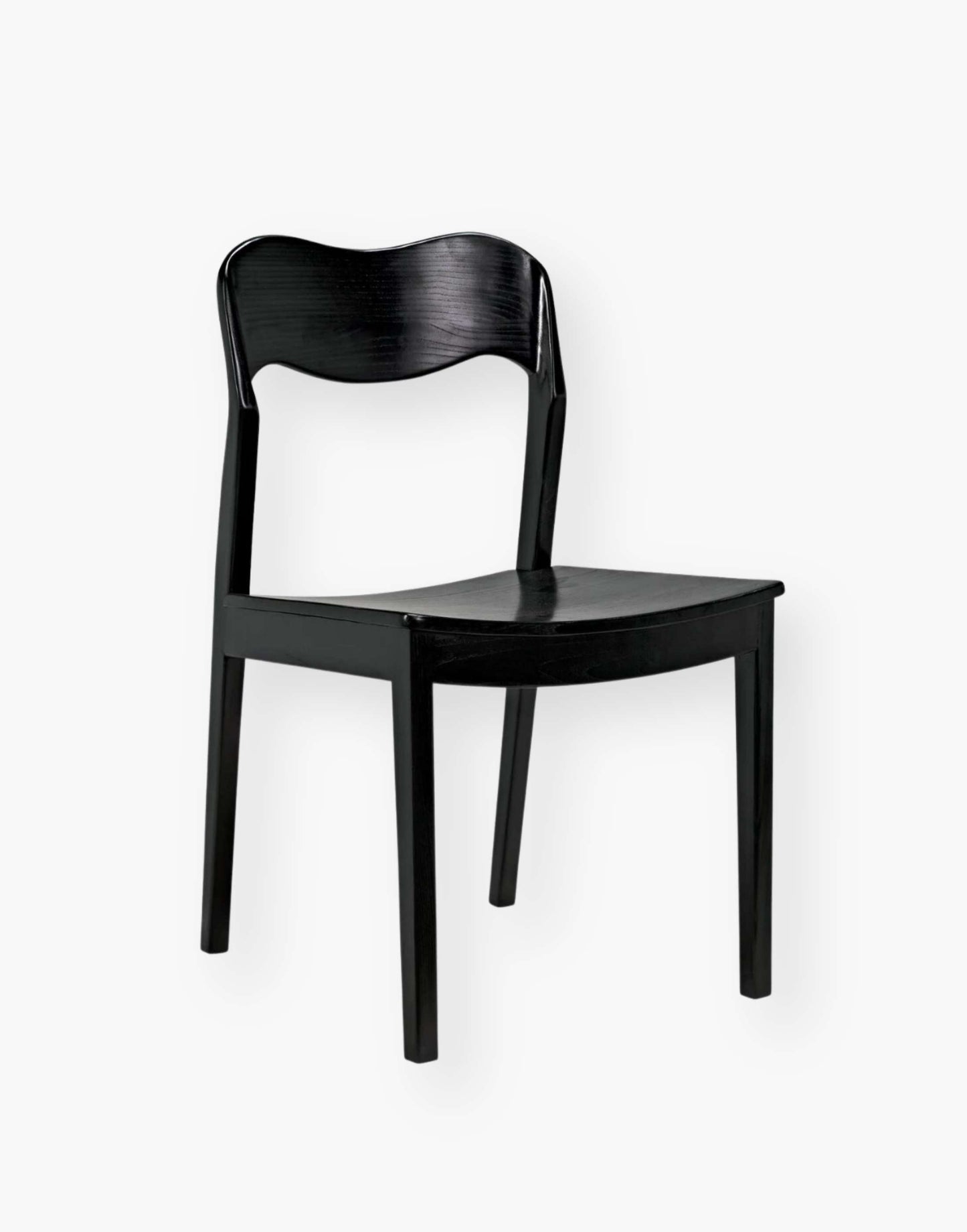 Dining chair with a subtly scalloped back and a curved seat with a black-finished sungkai wood frame.