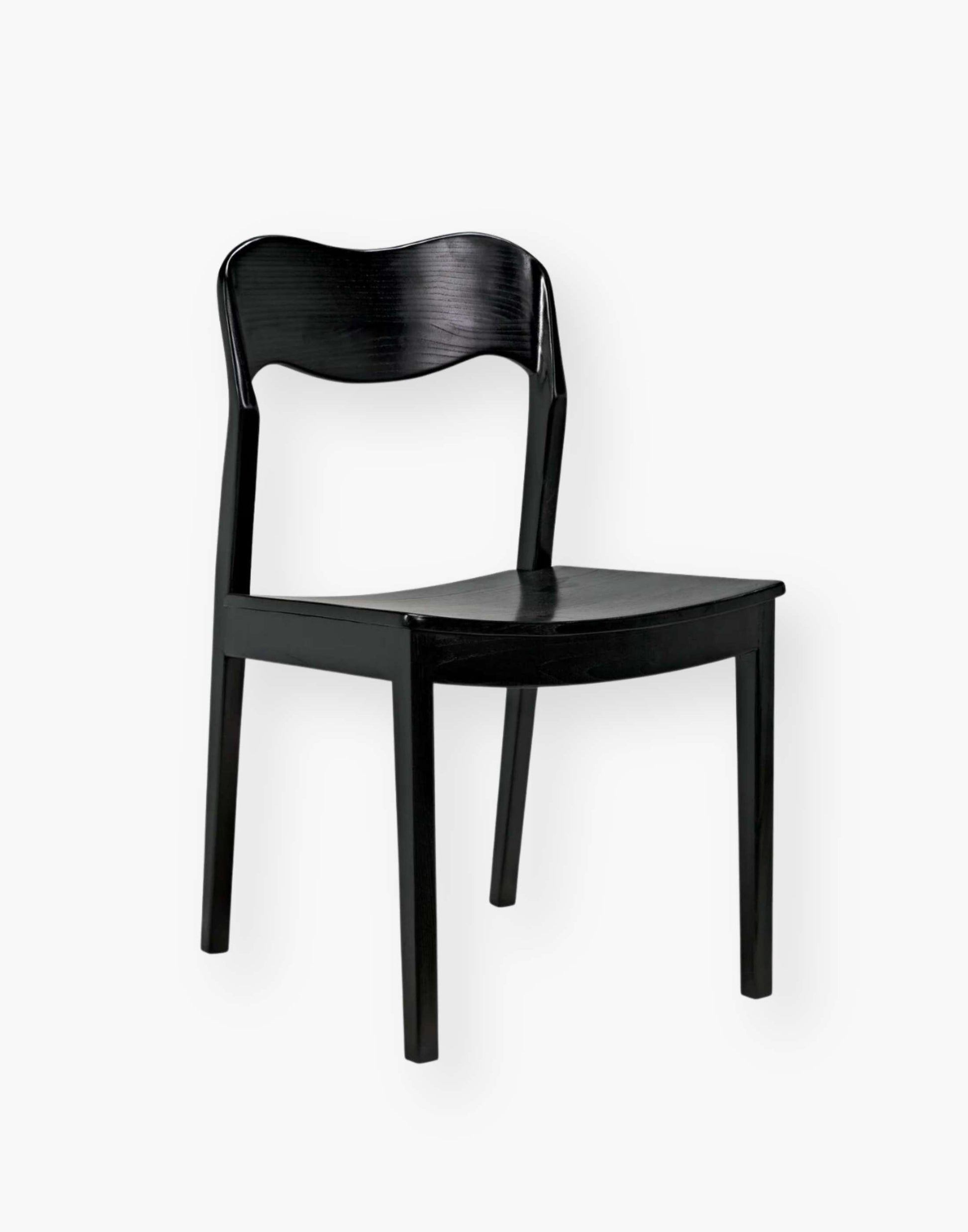 Dining chair with a subtly scalloped back and a curved seat with a black-finished sungkai wood frame.