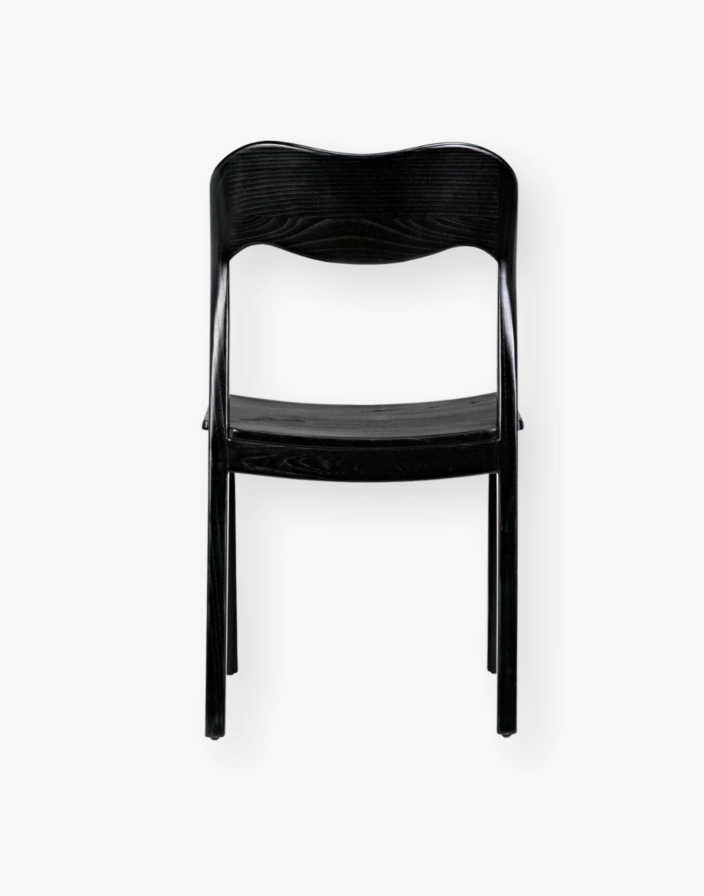 Dining chair with a subtly scalloped back and a curved seat with a black-finished sungkai wood frame.