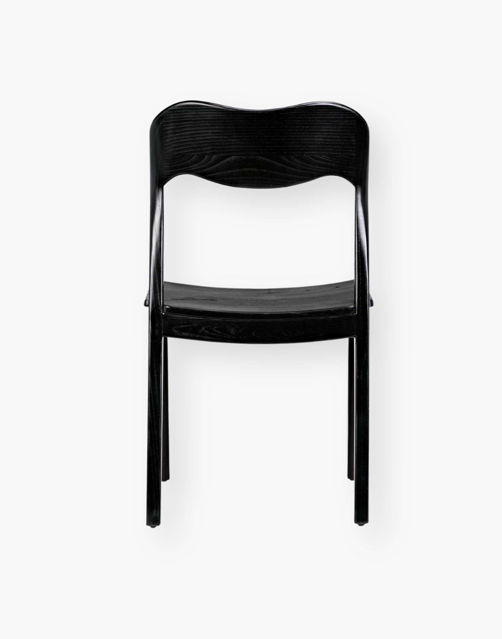 Dining chair with a subtly scalloped back and a curved seat with a black-finished sungkai wood frame.
