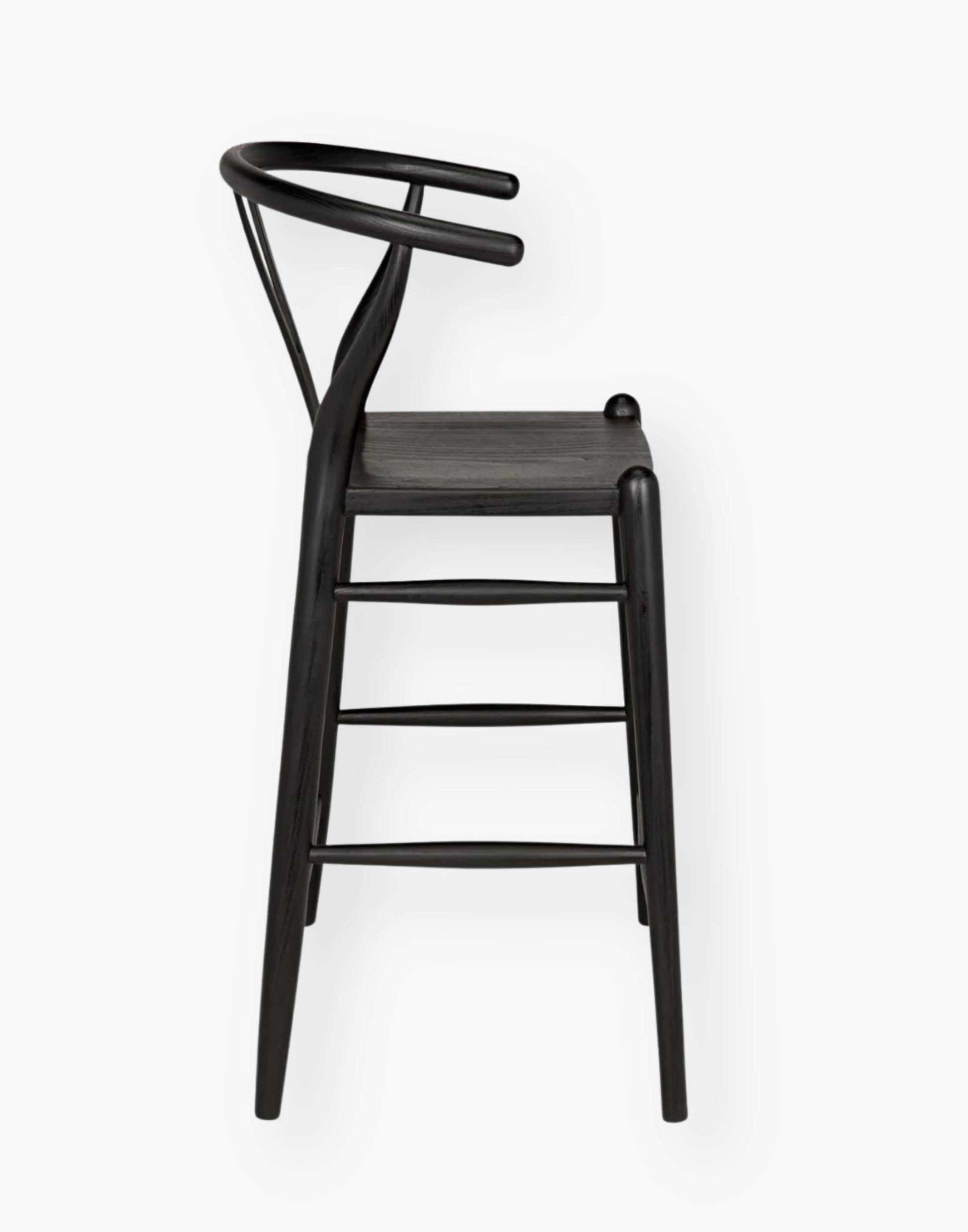 Counter stool that is hand-carved of sungkai wood with a charcoal black finish.